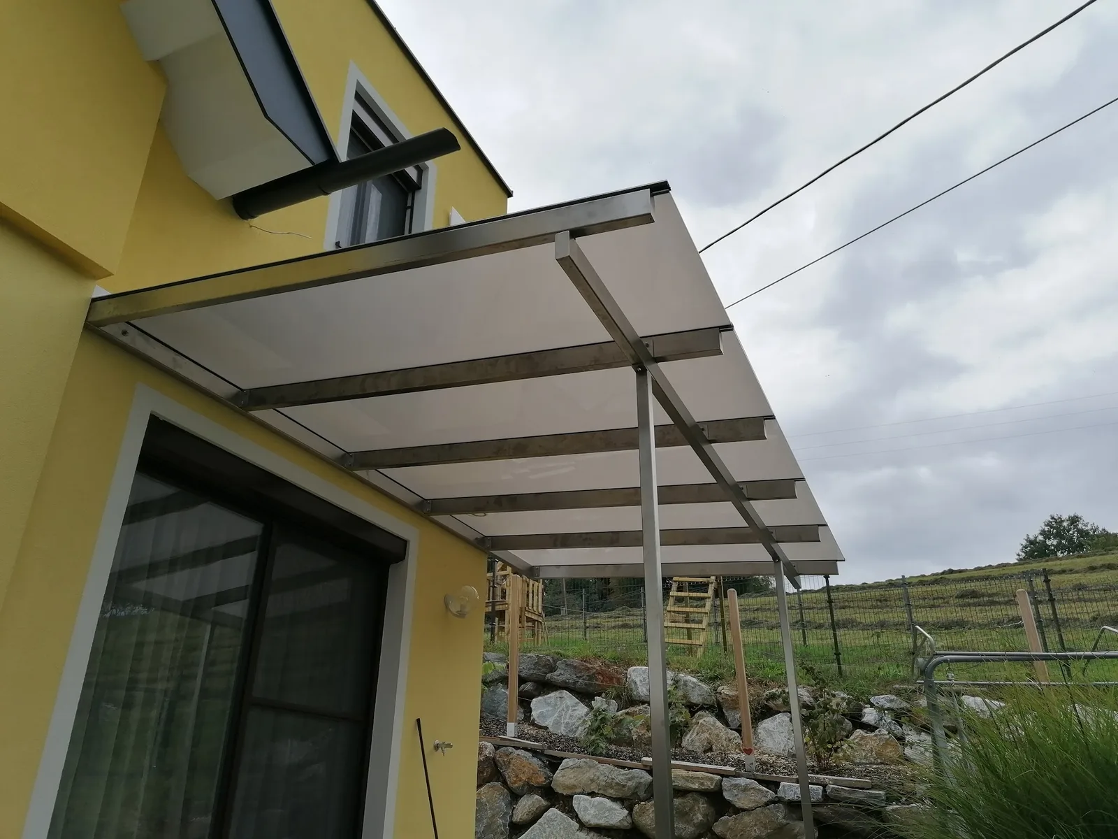 Terrassenüberdachung aus satiniertem Glas und Metall